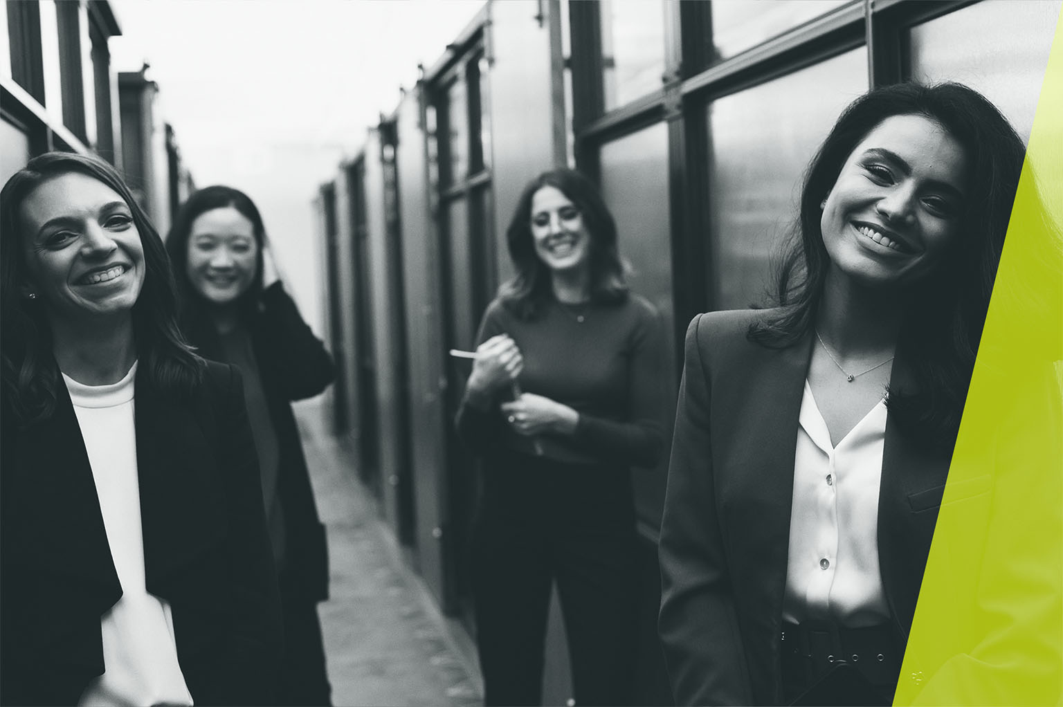 Team members of Heilbut LLP stand in a hallway, laughing and talking.